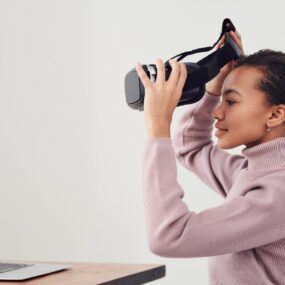 woman holding black vr headset